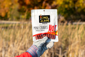Hot mini-craves held by gloved hand in field