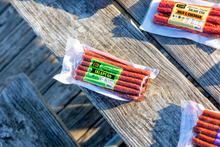Load image into Gallery viewer, Jalapeno and mIld &amp; cheddar salami stix on picnic table.
