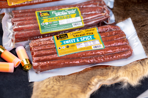 Sweet and spicy and habanero salami sticks on fur pelt.